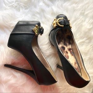 Black platform heels with gold belt buckle